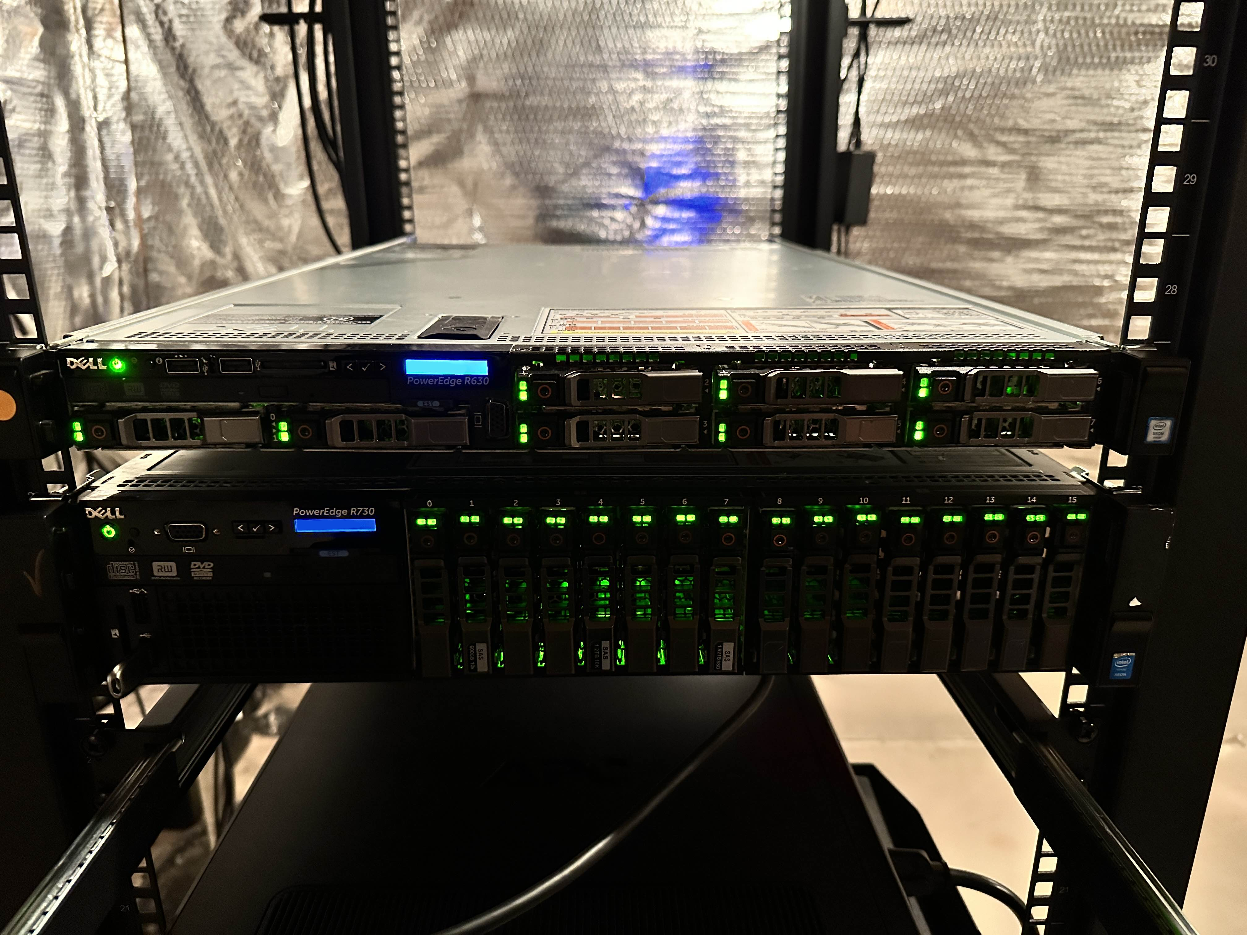 Two servers mounted in a server rack. A 1U Dell PowerEdge R630 and a 2U PowerEdge R730.