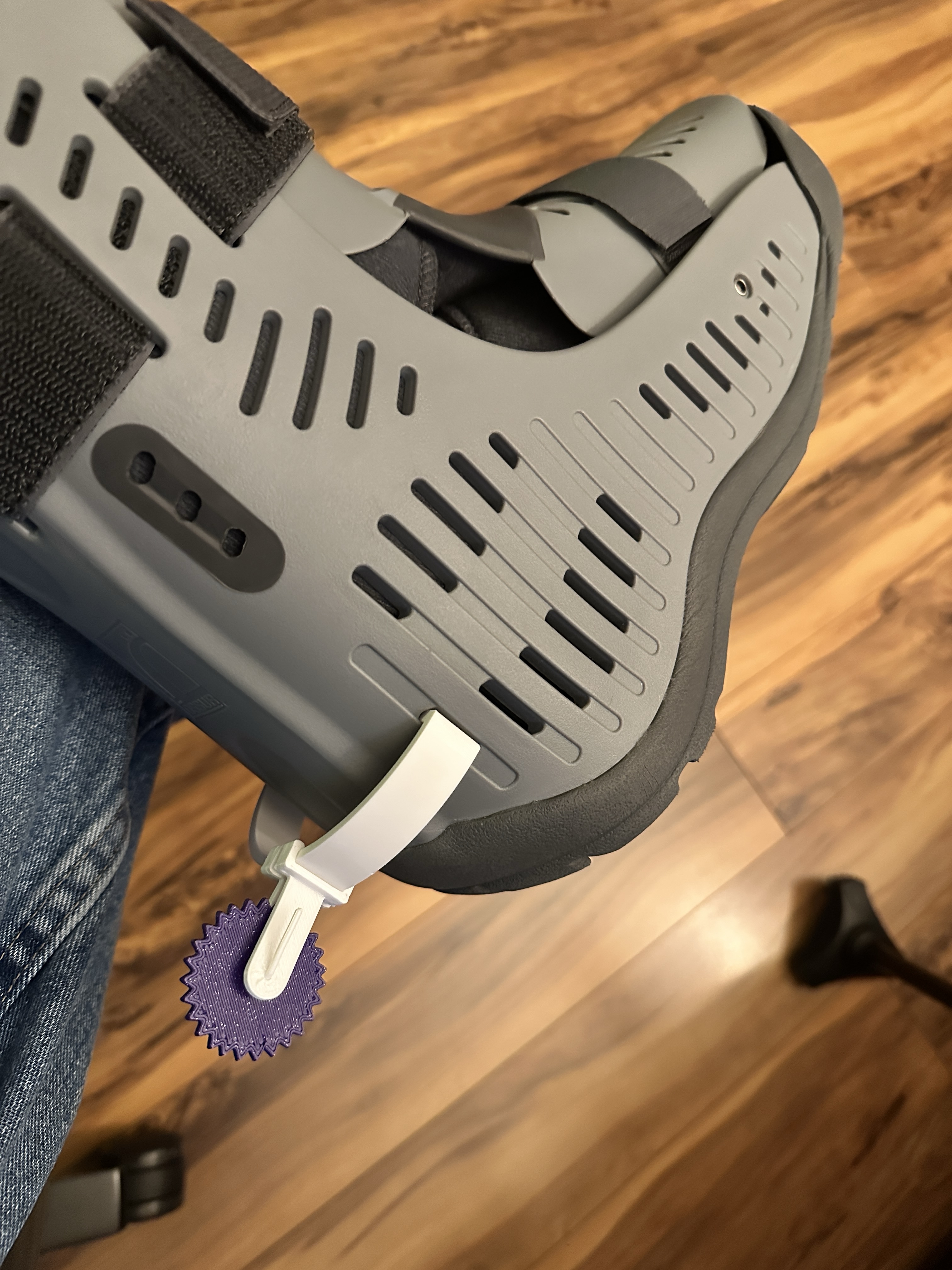 A photograph of a medical Air Boot with a Spur assembly attached to it. The
BootConnector and SpurConnector are printed in a white PETG, and the spur is
printed in a sparkle purple
PLA.